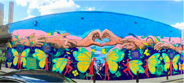 Street artist Majid Adin, Iranian refugee, “Choose Love” during 2018 Refugee Week in London Photo : Cassandre Brook